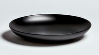 Minimalist black ceramic plate with soft shadow on white background, modern tableware design for contemporary dining and food presentation.