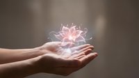 Hands holding glowing pink lotus flower with magical light effect, symbolizing wellness, spirituality, healing energy, and mindfulness practices for meditation and alternative therapy concepts.
