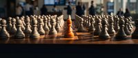 One golden chess pawn stands out among white pawns on wooden board, symbolizing leadership, uniqueness, and competitive advantage for business strategy concepts.