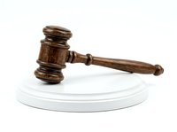 Wooden judge gavel with round white base, isolated on white background. Suitable for law, justice, legal services, court decisions, and business authority concepts.