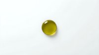 Yellow-green glass marble sphere isolated on white background for design projects and creative applications.