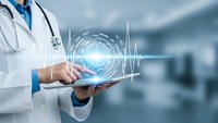 Doctor using digital tablet with holographic medical interface displaying heartbeat pulse and circular data visualization in modern hospital setting.