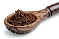 Ground coffee powder in wooden olive spoon on white background, macro food photography showing texture and aroma of fresh roasted coffee beans.