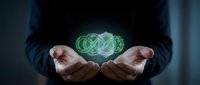 Business professional holding glowing green digital infinity symbol representing endless possibilities, growth and sustainable technology solutions.