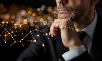 Thoughtful businessman in dark suit against glowing network visualization background with golden bokeh lights, contemplating strategic decisions.