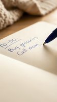 Handwritten to-do list on paper with blue pen showing daily tasks including buy groceries and call mom for organization and productivity planning.