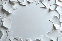 Torn white paper frame with ragged edges creating dramatic border effect against light background. Natural shadows add depth to layered composition.
