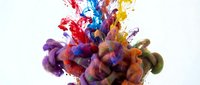 Vibrant multicolored paint explosion with dynamic splashes of red, blue, yellow, and purple creating an abstract burst of creativity and artistic energy.
