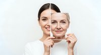 Aging concept showing young woman holding photo frame with senior woman face, illustrating beauty transformation and skin care over time.