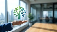 Businessman hand presenting green tree logo symbol in modern office environment representing growth, sustainability and environmental responsibility in corporate business.
