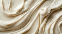 Smooth creamy white texture with soft waves and folds creating luxurious background pattern for cosmetic, food or abstract design projects.
