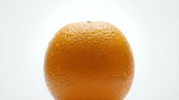 Fresh orange with textured peel isolated on white background, suitable for food, nutrition, and healthy lifestyle marketing materials.