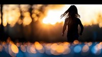 Woman silhouette running at sunset with bokeh lights creating dreamy atmosphere for fitness and wellness lifestyle concepts.