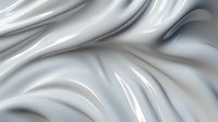 Elegant white silk fabric with soft flowing curves and gentle folds creates luxurious abstract background texture with light and shadow play.