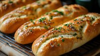 Fresh baked artisan bread loaves with herbs and seeds cooling on wire rack. Golden brown crusty bakery products for restaurant menu and food photography.