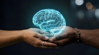 Glowing blue holographic brain floating above cupped hands against dark bokeh background representing artificial intelligence and mental health concepts.