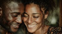 Happy African American couple sharing intimate moment together smiling with joy and love in warm golden light for relationship and romance concepts.
