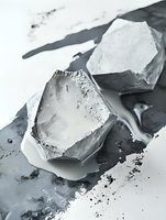 Broken ice cubes melting on dark surface creating water puddles and droplets in monochrome style for beverage and cooling concepts.