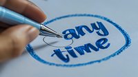Hand writing blue text with fountain pen on white paper, close-up view showing calligraphy process and artistic lettering style in circular frame.