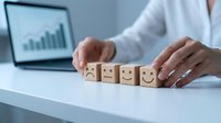 Business professional arranging wooden blocks with emotion faces from sad to happy showing customer satisfaction improvement concept.