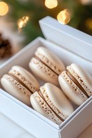 White French macarons with delicate filling arranged in elegant gift box against soft bokeh background, close-up view shows texture and layers of gourmet pastries.