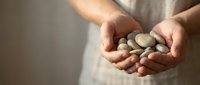 Woman hands holding collection of smooth river stones and pebbles for spa wellness meditation zen balance natural healing therapy relaxation mindfulness.