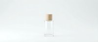 Small glass bottle with wooden cork stopper on white background, minimalist cosmetic container for essential oils, perfume or skincare products.