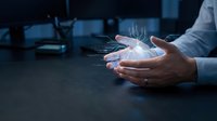 Businessman holding glowing digital hologram with upward trending graph and data visualization, representing financial growth, technology innovation, and business analytics in modern workplace.