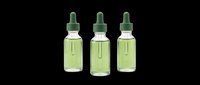 Dropper bottles with green liquid isolated on transparent background, ready for cosmetics, skincare, wellness, and supplement product design, packaging mockups, and print-on-demand applications.