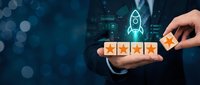 Hand placing fifth star in customer rating system with rocket launch icon representing business growth and excellence in service quality evaluation.