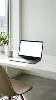 Modern laptop with blank white screen on minimalist desk workspace with coffee cup and plant for remote work and productivity mockup design.