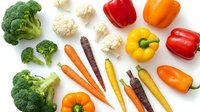 Fresh organic vegetables collection featuring broccoli, colorful bell peppers, cauliflower and rainbow carrots isolated on white background for healthy cooking.