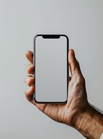 Male hand holding modern smartphone with blank white screen against light gray background. Mockup for app or website presentation.