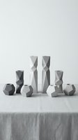 Modern geometric ceramic vases collection in neutral gray tones arranged on linen tablecloth, minimalist home decor and interior design styling.