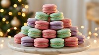Colorful French macarons pyramid on white plate with warm Christmas lights bokeh background creating festive holiday dessert display for celebrations.