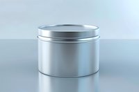 Empty silver metal tin container with lid on reflective surface, perfect for product mockup and packaging design presentation in cosmetic or food industry.