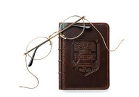Vintage round eyeglasses with metal frames and brown leather journal isolated on white background, ready for design projects, educational materials, and lifestyle compositions.