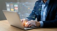 Professional businessman analyzing financial data on laptop with holographic charts and graphs overlay for business intelligence and market research.