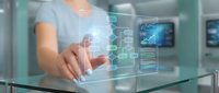 Female professional in light blue shirt interacting with holographic digital interface displaying data analytics, network connections, and charts in modern tech environment for business solutions.