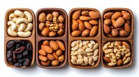 Mixed nuts and dried fruits in wooden compartment boxes arranged in two rows. Assortment includes cashews, walnuts, almonds, pecans, raisins and other healthy snacks.