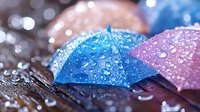 Colorful paper umbrellas with water droplets in macro photography. Artistic bokeh background creates dreamy atmosphere with blue and pink pastel colors and sparkling effects.