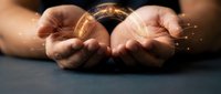 Male hands holding glowing golden coin with sparkling light effects, representing wealth, investment, cryptocurrency, financial success, and money management concepts.
