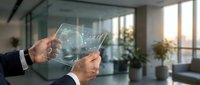 Businessman hands holding transparent digital tablet displaying holographic data analytics charts and graphs in modern office environment.