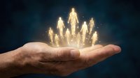 Caucasian male hand holding glowing golden human figures against dark blue background, representing team growth, leadership, success, and business development for corporate and motivational concepts.