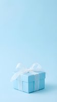 Light blue gift box with white ribbon bow on matching blue background, isolated present for celebrations, holidays, birthdays, and special occasions.