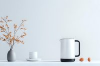 Minimalist kitchen counter with electric kettle, coffee cup, gray vase with dried orange flowers and eggs against white wall, modern scandinavian interior design.