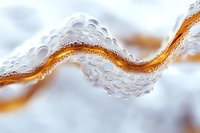 Abstract macro photography of water droplets forming wave pattern with golden curved line against soft white background. Creative fluid art composition.
