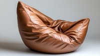 Luxurious brown leather bean bag chair with soft folds and creases against neutral background, showcasing modern furniture design for contemporary living spaces.