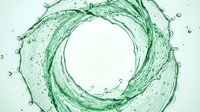 Green liquid splash in circular motion with water droplets isolated on white background, suitable for cosmetics, skincare, and beverage packaging design.