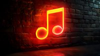 Glowing red neon music note sign on dark brick wall background creates atmospheric mood lighting with reflection on concrete floor surface.